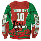 Personalized South Sydney Rabbitohs ANZAC Tribute Sweatshirt Poppy Field Soldier Silhouette Aboriginal Rugby Mascot